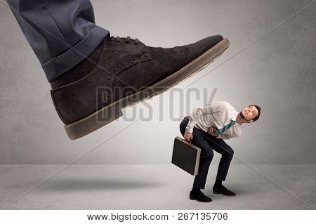 Young businessman illustrated inconsiderable by being trampled
