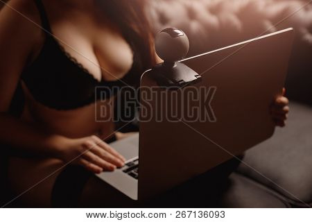 Seductive Woman Working On As Internet Webcam Model. Concept Virtual Sex Chat.