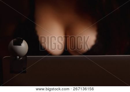 Woman Working As Internet Webcam Model. Shows Breasts. Concept Virtual Sex Chat.