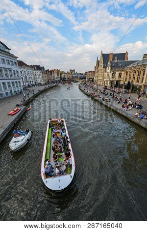 Ghent, Belgium - Oct 5, 2018. Medieval Brick Merchant Houses And Tourist Cruise Boat On Graslei And 