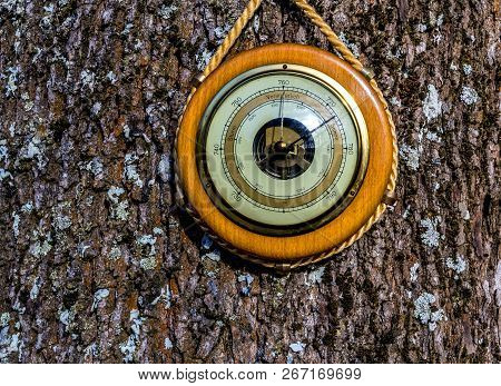 Old Barometer On Textured Wooden Surface. Concept Of Forecasting. Translations From German To Englis