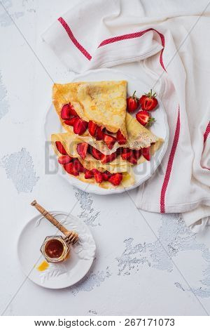 Сrepes With Fresh Strawberries And Caramel On Light Concrete Old Table Background. Top View.