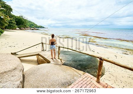 A Woman Tourist On Tropical Beach At Praslin (anse Cimitiere), Seychelles