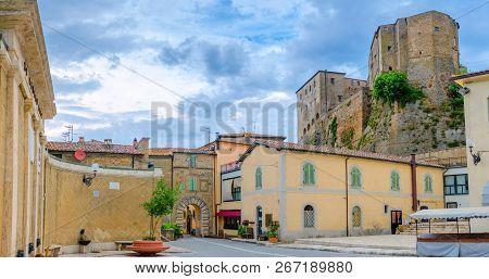 street of the old city of Siena overlooking the tower of Torre del Manja, Sienna. Italy