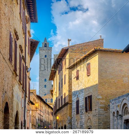 street of the old city of Siena overlooking the tower of Torre del Manja, Sienna. Italy