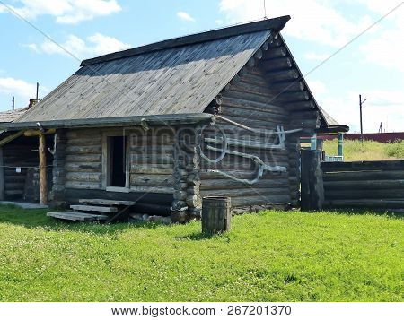 Peasant Farmstead Of The Xvii-th Century. A Fragment Of The Facade And Palisade. Log Hut In Ural Vil