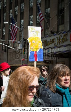 March For Our Lives: Participants in the march to end gun violence on 6th Ave hold signs with various phrases including illustrations of Predsident Donald Trump, NEW YORK MAR 24 2018.