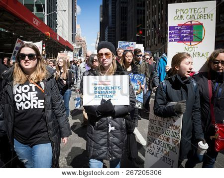 March For Our Lives: Participants in the march to end gun violence hold signs with various phrases Students Demand Action, on 6th Ave, NEW YORK MAR 24 2018.