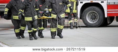 Italy - May 10, 2018: Stretcher Bearers Firemen Transport An Injured On The Stretcher During A Pract