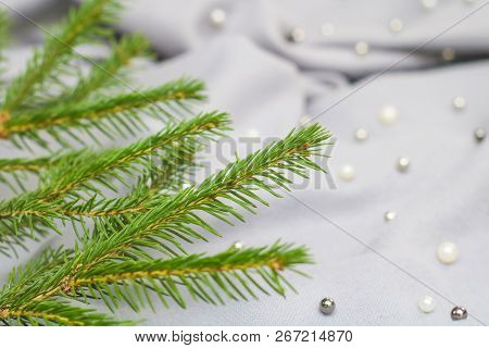 Green Branches Of Spruce With A Cozy Warm Knitted Scarf, Place For Text. Rustic Christmas Tree And W