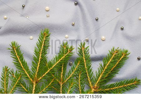 Green Branches Of Spruce With A Cozy Warm Knitted Scarf, Place For Text. Rustic Christmas Tree And W
