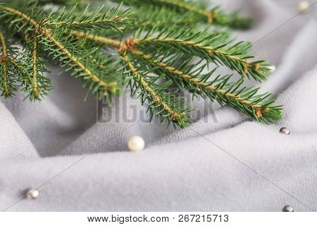 Green Branches Of Spruce With A Cozy Warm Knitted Scarf, Place For Text. Rustic Christmas Tree And W