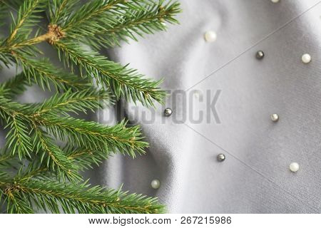 Green Branches Of Spruce With A Cozy Warm Knitted Scarf, Place For Text. Rustic Christmas Tree And W