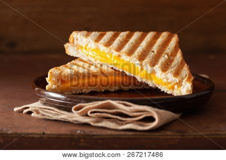 grilled cheese sandwich on rustic brown background