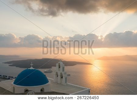 Sunset Over Aegean Sea With View To Virgin Mary Catholic Church Three Bells Of Fira, Santorini.