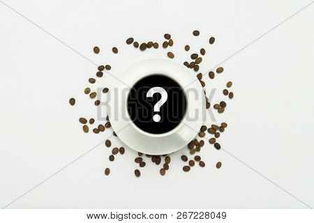 White Cup With Black Coffee, Grains Of Coffee, On A White Background. Question Mark. Flat Lay, Top V