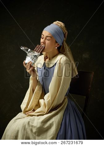Medieval Woman In Historical Costume Wearing Corset Dress And Bonnet. Beautiful Peasant Girl Wearing
