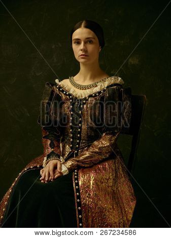 Portrait Of A Girl Wearing A Princess Or Countess Dress Over Dark Studio