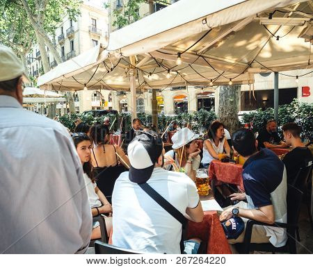 Barcelona, Spain - Jun 1, 2018: People Having A Nice Lunch On The Rambla Dels Estudis In Central Bar