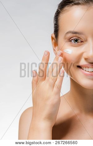 Young Beautiful Woman Applying White Cream On Cheek