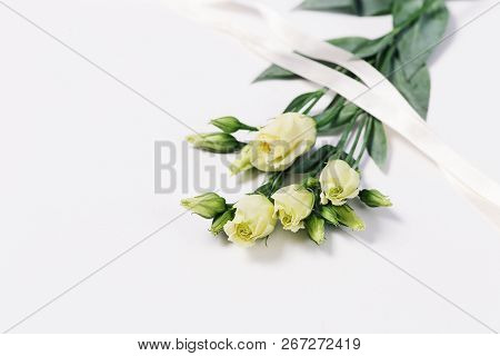 Bunch Of White Eustoma On Light White Background With Copy Space. Floral Greeting Card For Invitatio