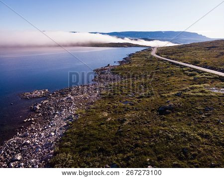 Aerial View. Road Crossing Hardangervidda Mountain Plateau, Clouds Over Lakes, Morning Time. Norway 