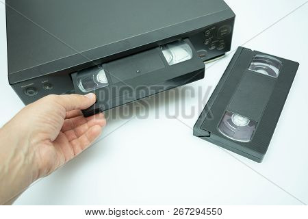 Vhs Videocassette Is Put Into The Video Recorder To Watch The Video, Another Video Cassette Is On Th