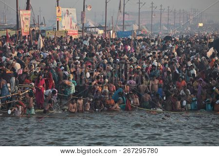 ALLAHABAD, INDIA - FEBRUARY 12, 2013: Thousands of Hindu devotees come to confluence of the Ganges and Yamuna River for holy dip during the festival Kumbh Mela. The world's largest religious gathering