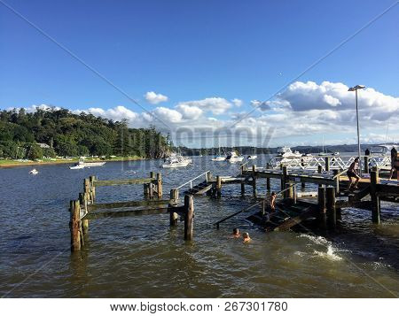 Russel, North Island, New Zealand - February 19th, 2016: A Group Of Young Kids Enjoying The Sun Swim