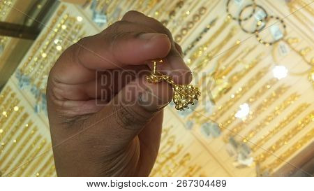 Earring On Hand.photo Taken From Jewelry.gold Earring