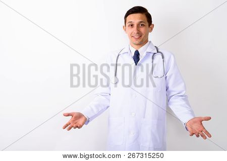 Studio Shot Of Young Happy Man Doctor Smiling While Looking Conf