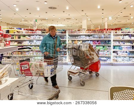 Bremen, Germany - Oct 27, 2018: Woman Near Shopping Cart With Food And Non Food Products Inside Edek