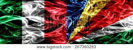 Italy Vs Seychelles, Seychelloise Smoke Flags Placed Side By Side. Thick Abstract Colored Silky Smok