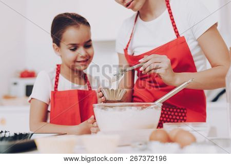 Mom And Girl Cook In Kitchen. Little Girl With Young Mother. Joi Kid With Mom Preparation Breakfast 