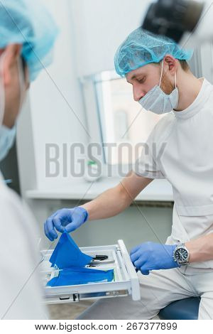 Doctor Used Microscope. Dentist Is Treating Patient In Modern Dental Office. Operation Is Carried Ou