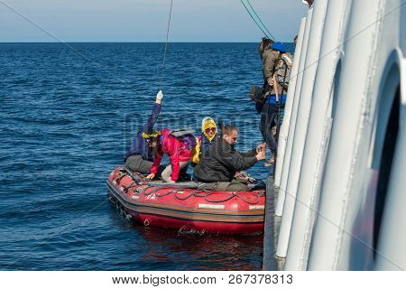 Island Anzersky, Russia - June 26, 2018: Tourists Land On The Island Of Anzersky From The Ship On An