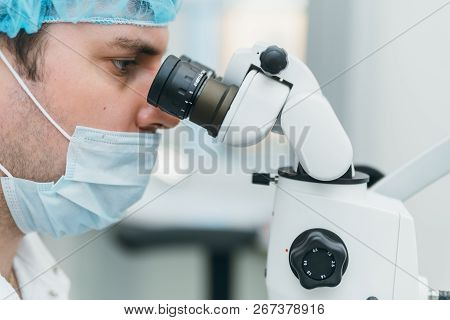 Doctor Used Microscope. Dentist Is Treating Patient In Modern Dental Office. Operation Is Carried Ou