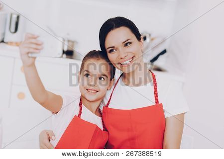 Smile For Selfie Mom And Young Girl. Sweet Time Together. People Smile In Kitchen. Young And Heppy G