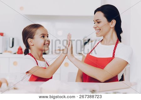 Happy Girl And Happy Mother In Kitchen. Smile Mother And Daughter. Cook Together With Mother. Family