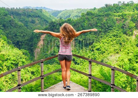 Family Vacation Lifestyle. Young Woman Stand On Edge Of Overhanging Bridge On High Cliff. Happy Girl