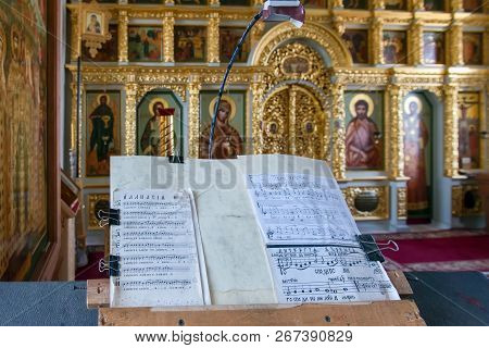 Island Anzersky, Russia - June 26, 2018: Music Stand With Notes In Front Of The Altar Of The Church 