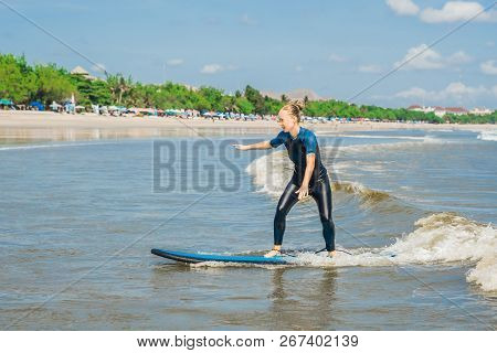 Joyful Young Woman Beginner Surfer With Blue Surf Has Fun On Small Sea Waves. Active Family Lifestyl