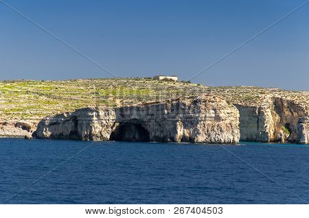 Cliffs And Rocks Of The Island Of Comino Or Kemmuna Of The Maltese Archipelago In The Mediterranean 
