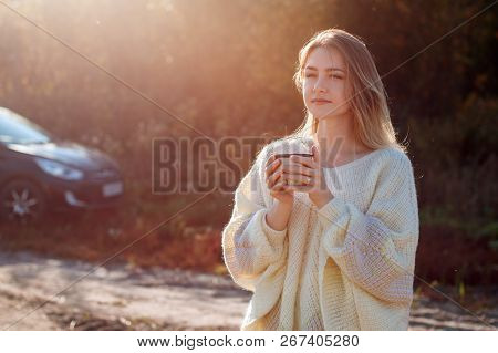 Beautiful Admiring Woman Drinking Hot Tea From Thermos Cup With Backligth Sun.
