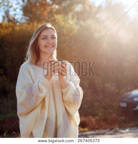 Beautiful Admiring Woman Drinking Hot Tea From Thermos Cup With Backligth Sun.