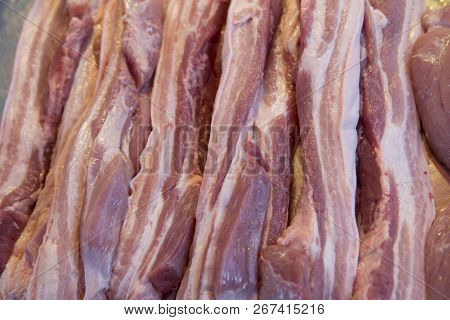 Close Up Of Cutting Streaky Pork In Fresh Market. Background And Texture Of Streaky Pork.