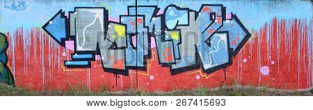 Full And Acomplished Graffiti Artwork. The Old Wall Decorated With Paint Stains In The Style Of Stre