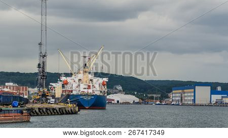 Gdynia, Pomerania / Poland - 2018: A Big Freighter At The Port Transhipment Terminal