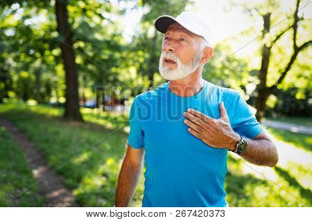 Mature Man Exercising Outdoors To Prevent Cardiovascular Diseases And Heart Attack
