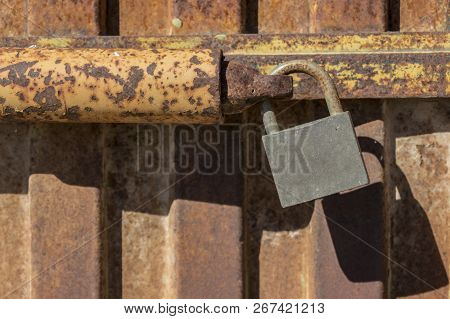 Padlock Closing Rusty Metal Door, Old Rusty Iron Door With Closed Locks, Close Up Padlock On The Doo